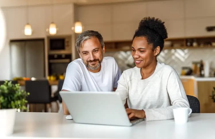 Man and women looking at laptop