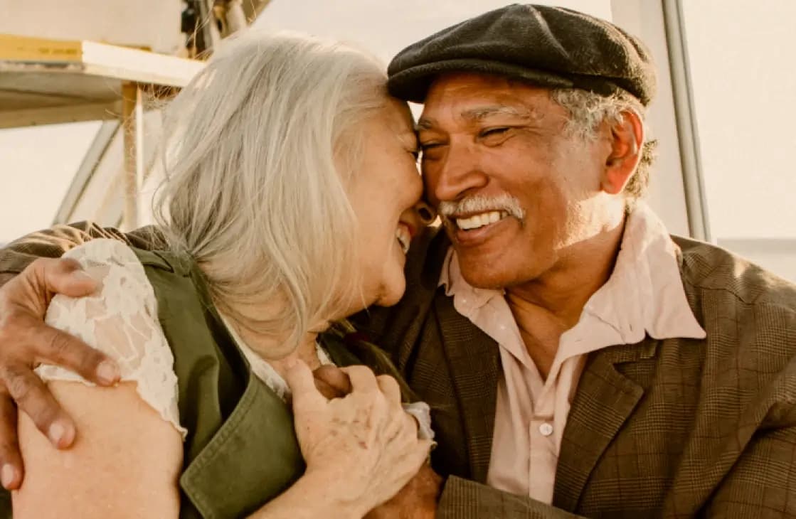 Man and women holding hands and smiling